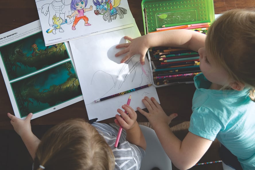 Two preschoolers drawing and coloring together