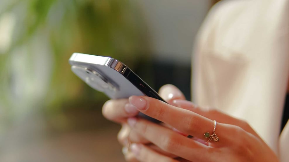 Woman Giving to Church Through Text on Phone