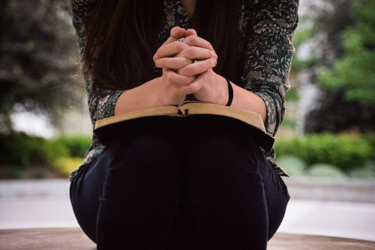 the best christian closing prayer Woman Praying with Bible - Closing Blog