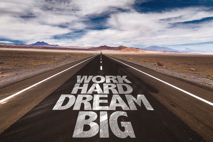 Work Hard Dream Big written on desert road