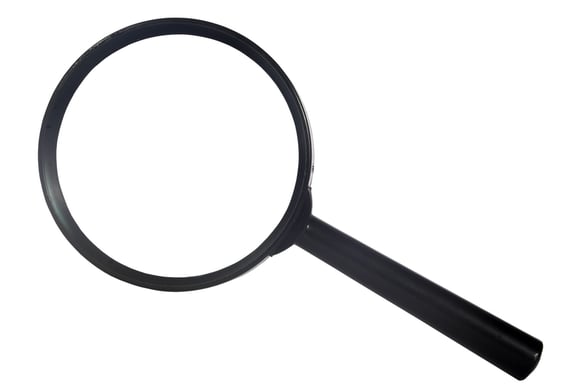 black magnifying glass over white viewed from the top
