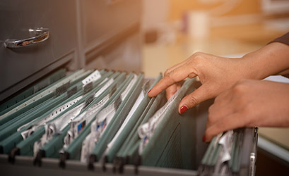 Hand-pulling-documents-from-drawer