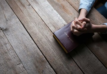digital church bulletin blog-man with folded hands over bible