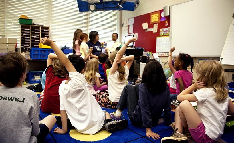 daycare-children-sitting-on-floor-with-teacher
