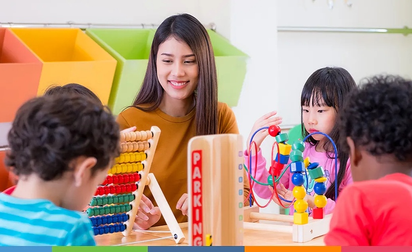 early-childhood-teacher-with-children-at-table