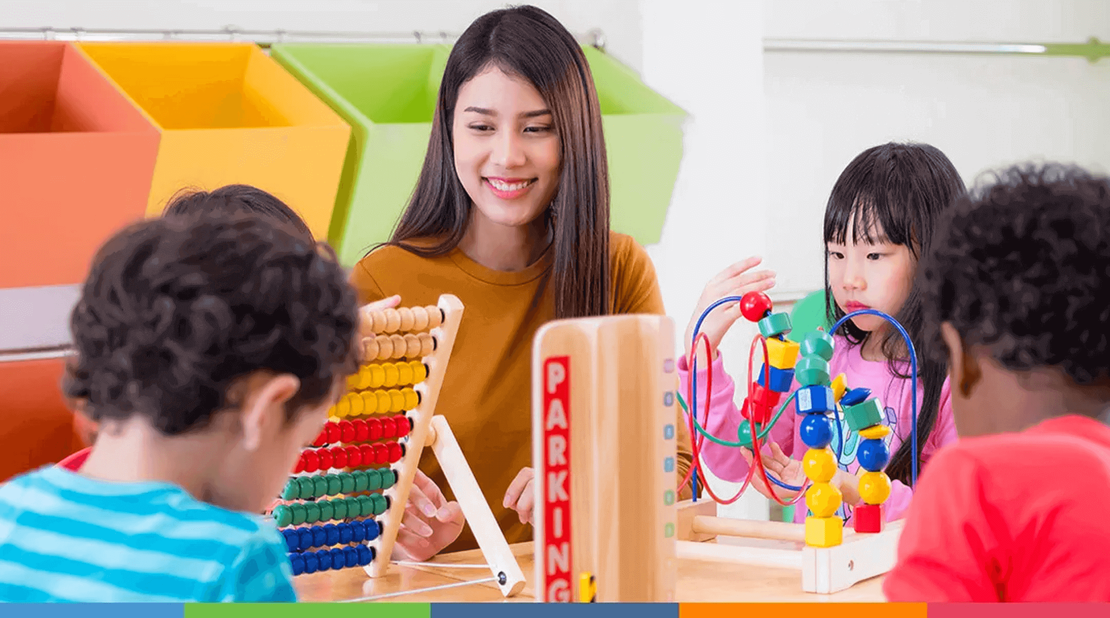 early-childhood-teacher-with-children-at-table-one-column