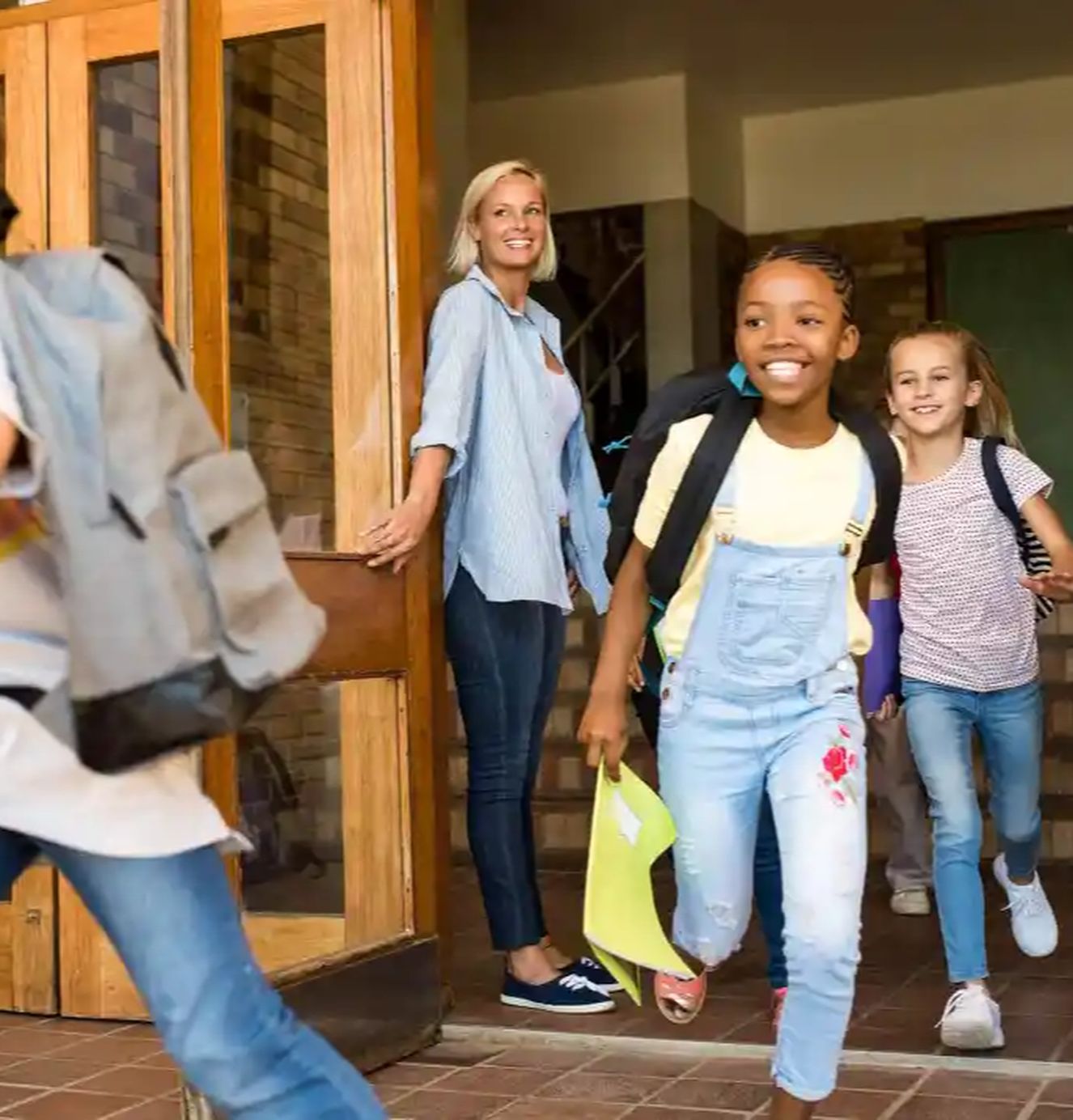 Teacher with children leaving after school program