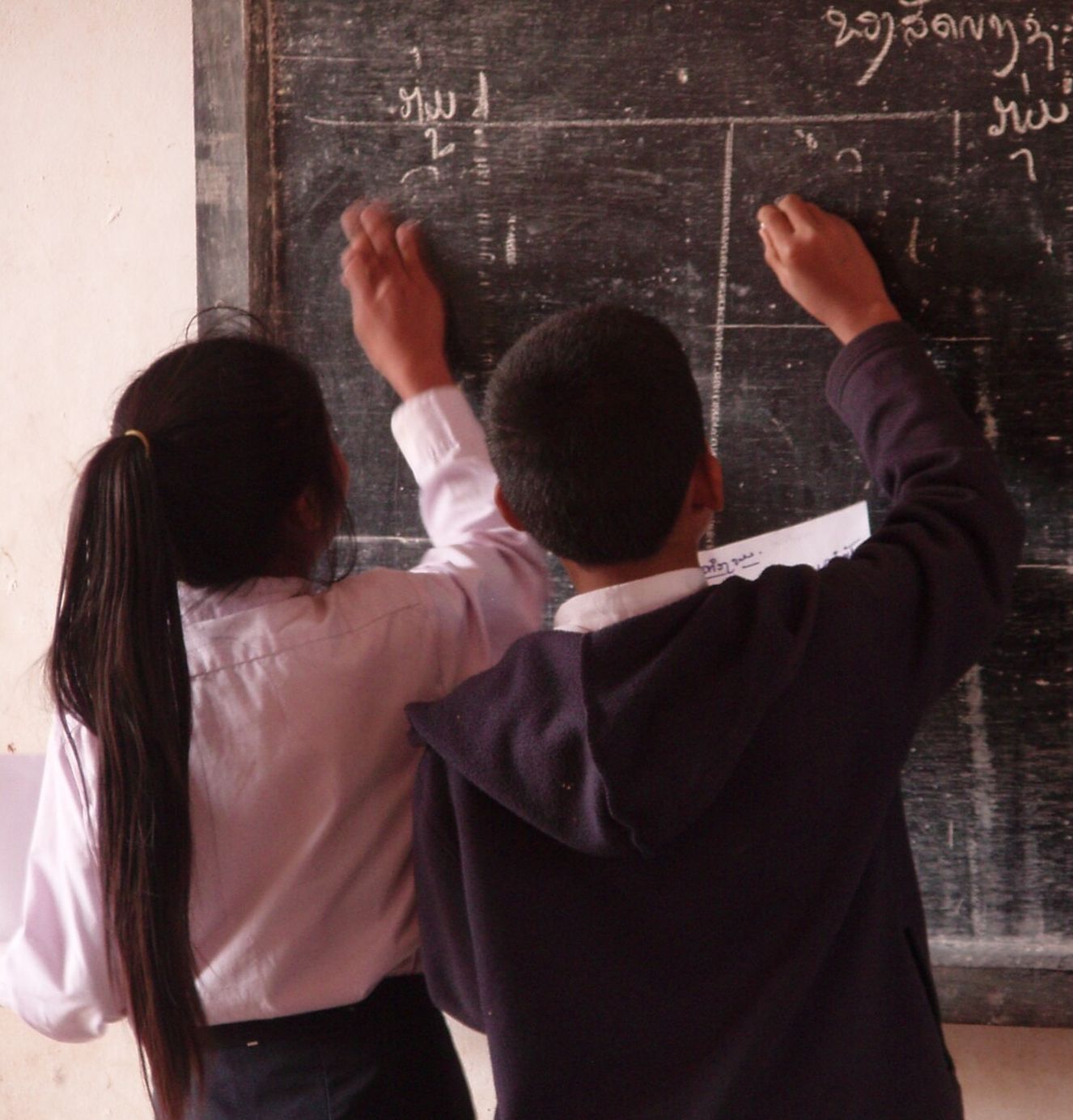 students-at-blackboard-two-column-tall