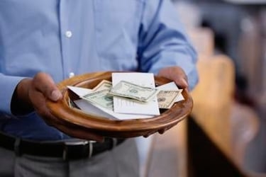 Man holding church offering plate for tithes