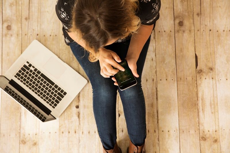 Woman on  Phone Donating to Church on Giving Tuesday