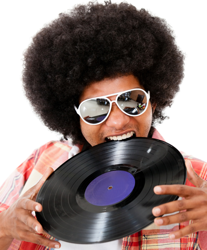 Disco man with an afro having fun - isolated over white background