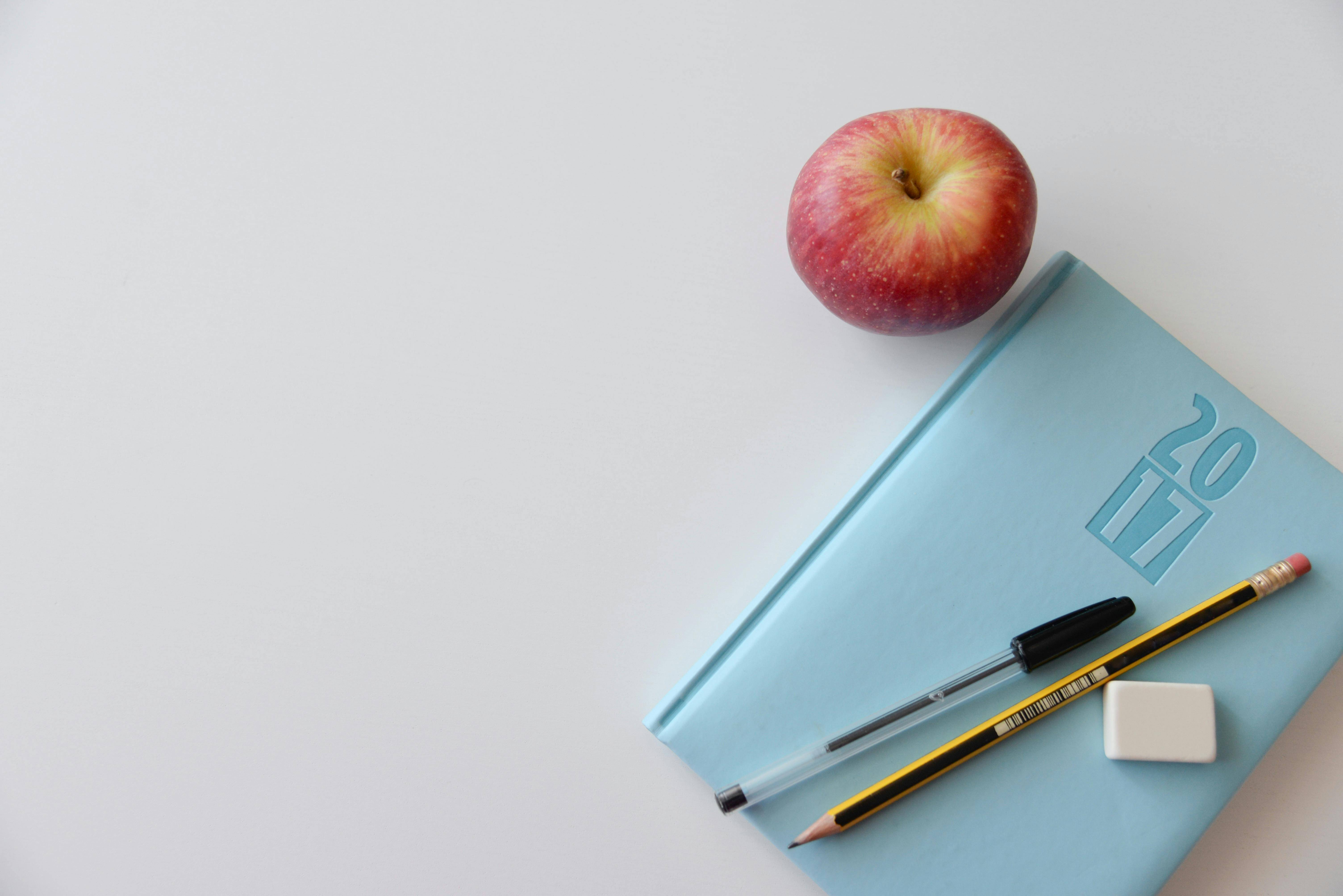 Image of a notebook and apple a student got from the high school concession stand