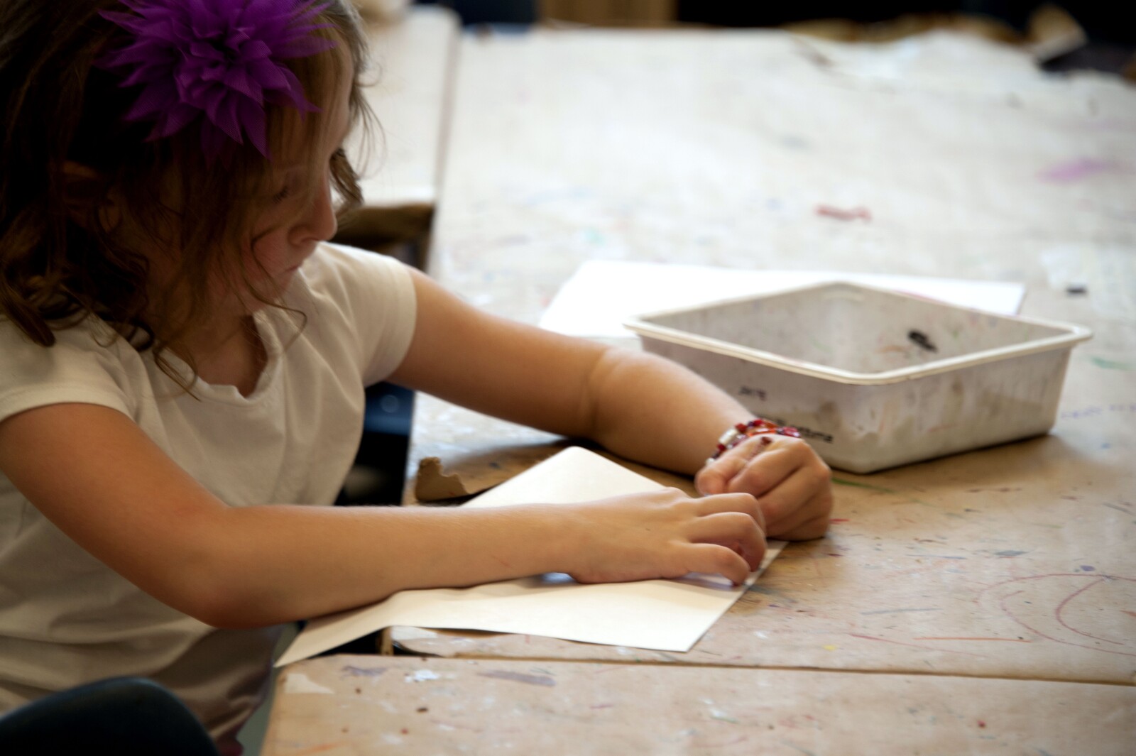 Preschooler Drawing with Paper and Her Supplies