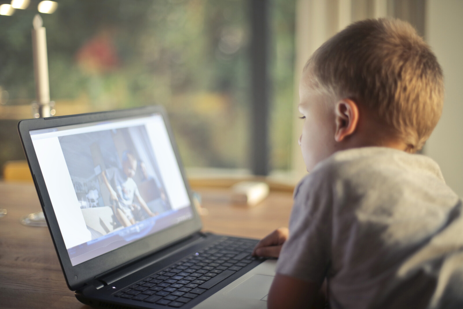 Preschooler watching video on laptop