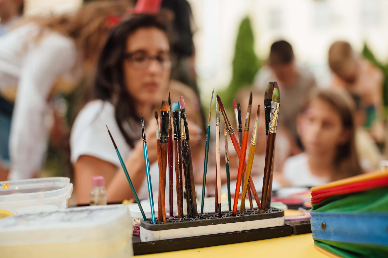 Volunteer and students during a painting fundraiser school event