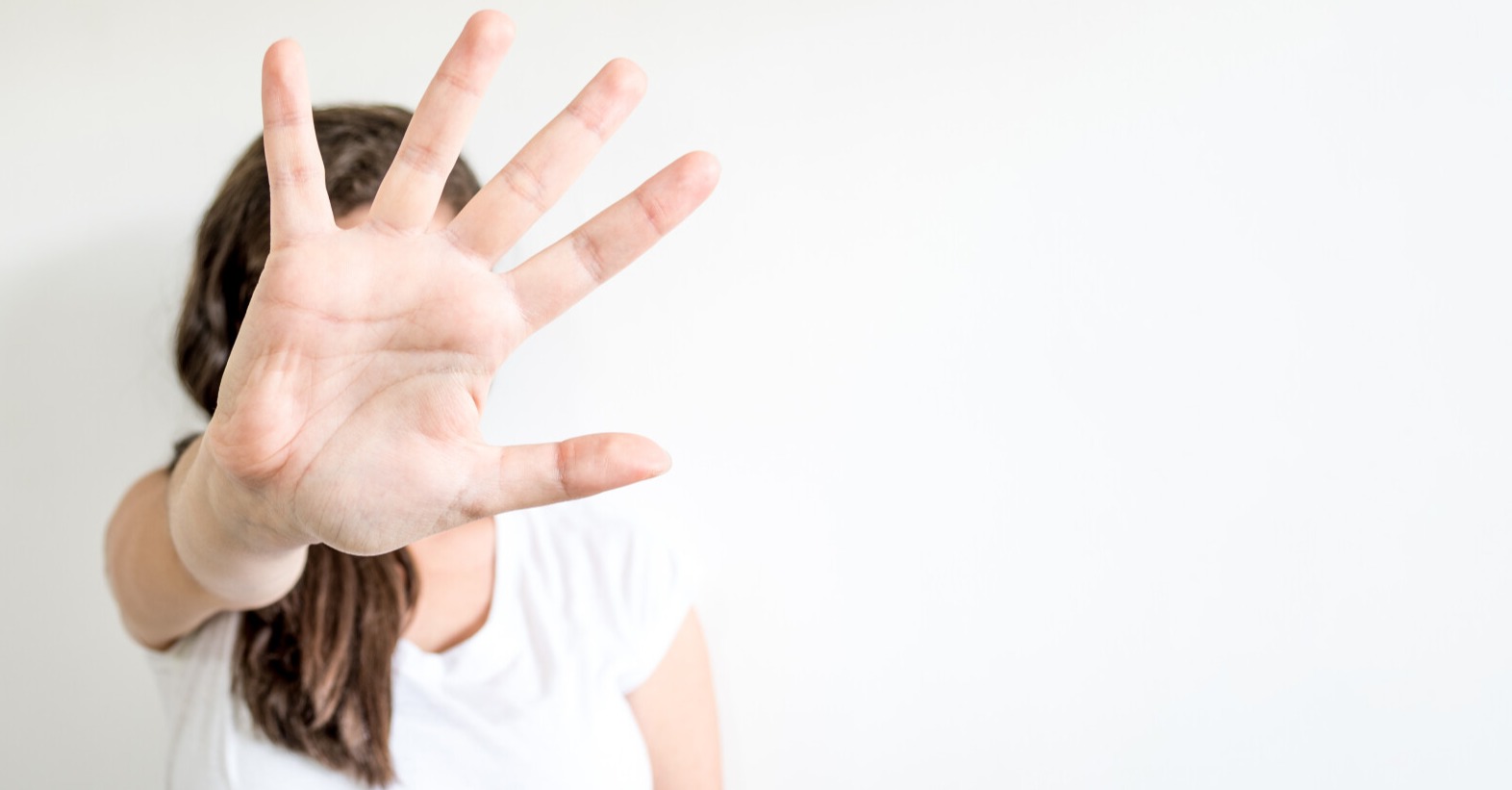 Woman holding out hand in refusal