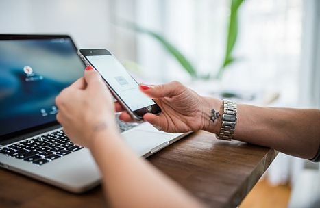 woman with phone and laptop