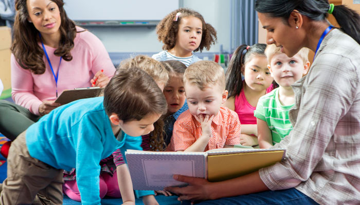 young children looking at book
